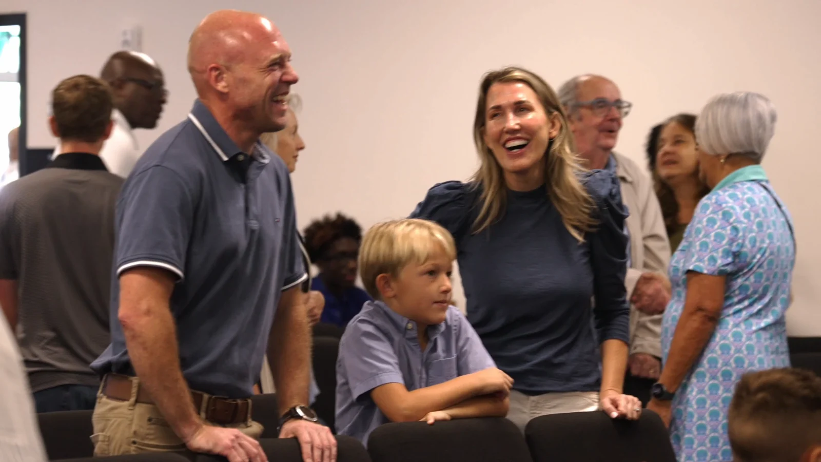 People smiling together at a Living Message Church gathering.